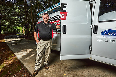 A Ragsdale Heating, Air Conditioning, Plumbing & Electrical technician next to a company vehicle