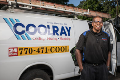 Coolray technician smiling upon arrival in front of van