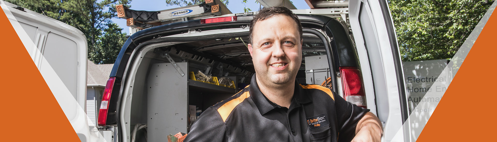 Britebox electrician smiling in front of a service van