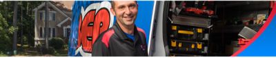 Plumber smiling by van