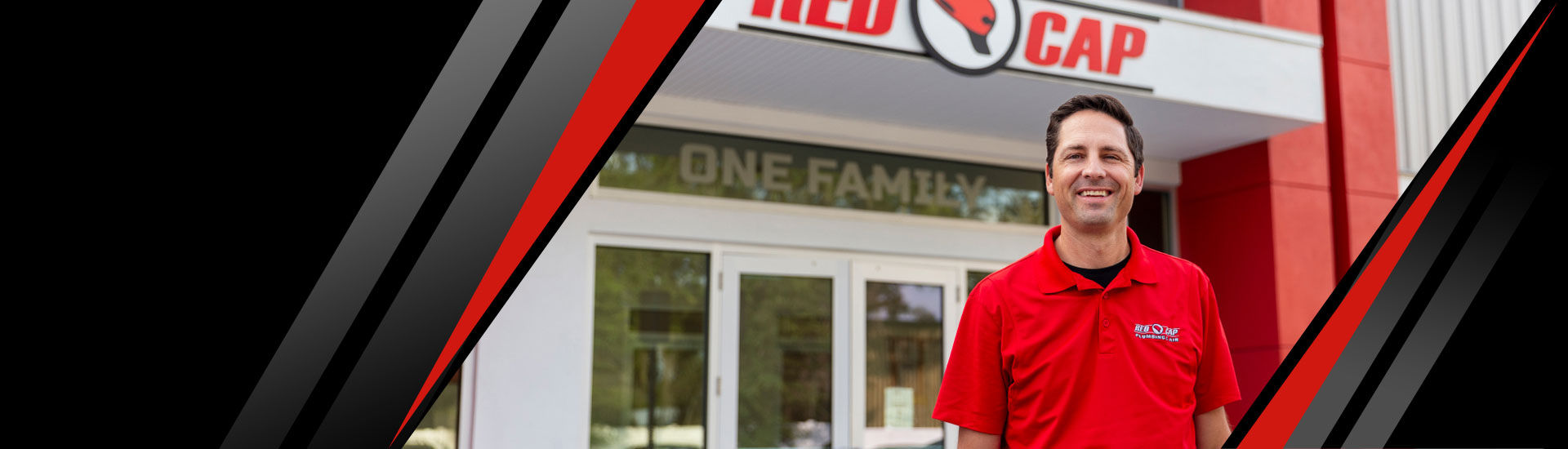 A technician from Red Cap smiling in front of the building