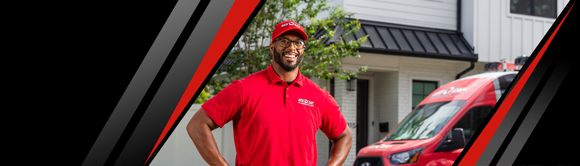 A smiling Red Cap technician standing in front of a house, and a Red Cap truck is parked behind