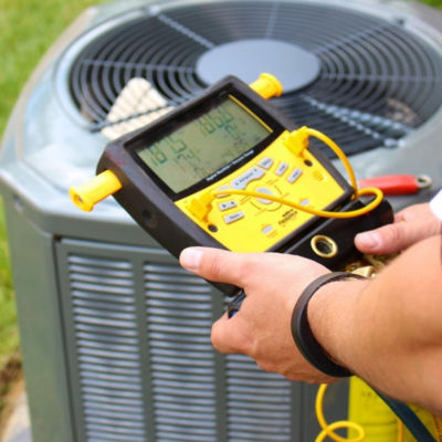 HVAC technician testing unit outdoors