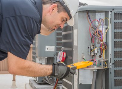 Technician testing HVAC unit