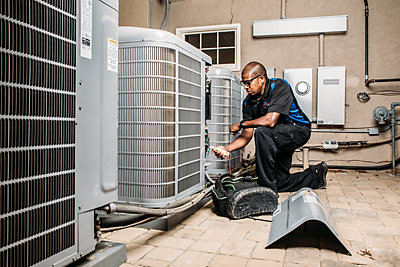 Technician working on air conditioner