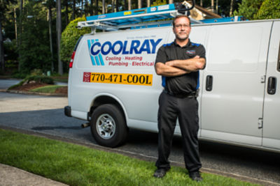 Coolray technician standing in front of van proud