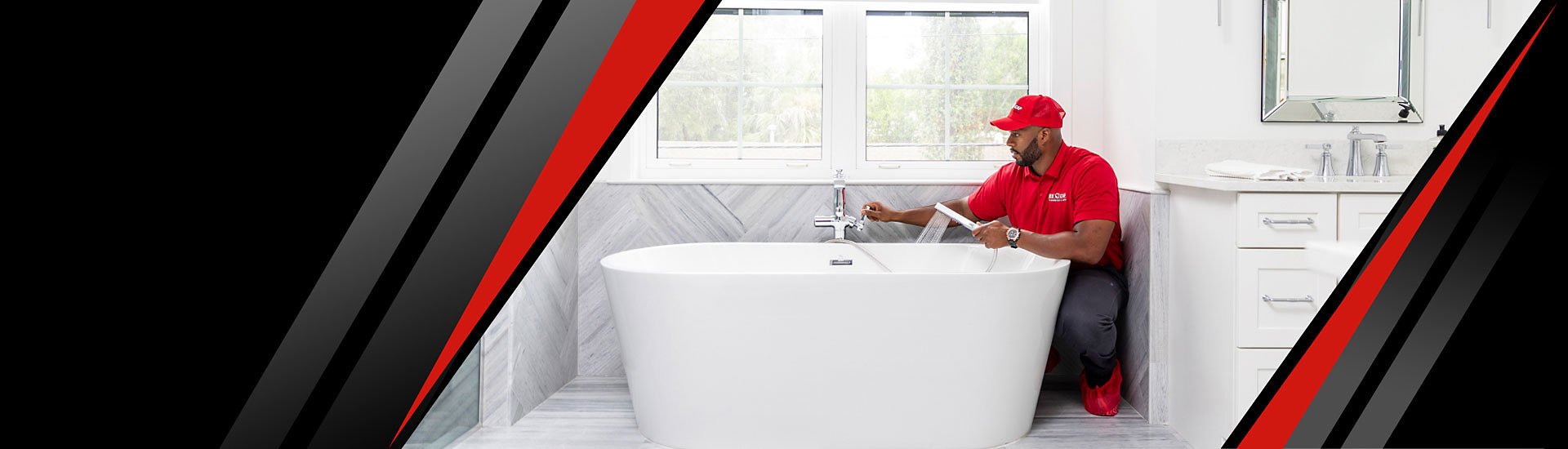 A Red Cap technician checking a bathtub in a bathroom
