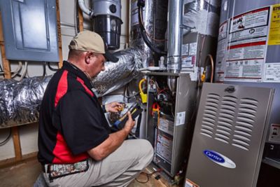 Ragsdale HVAC tech inspecting a furnace