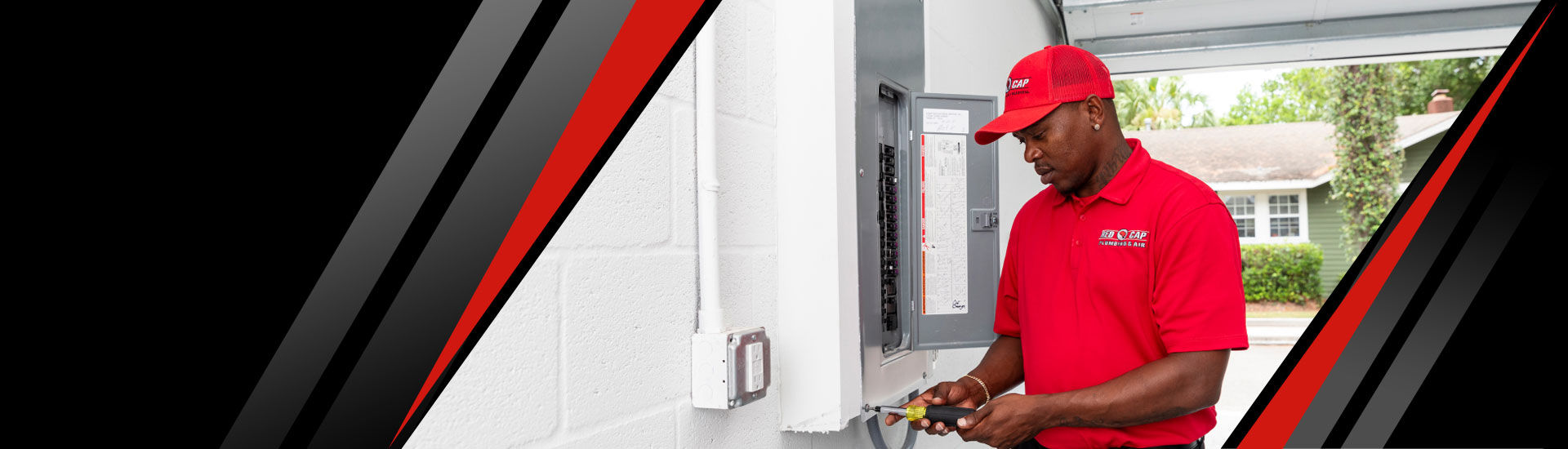 A Red Cap electrician inspecting an electrical panel in a Tampa home