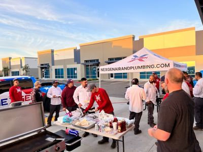 Nex Gen employees standing around tent