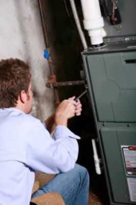 Technician dismantling furnace to inspect