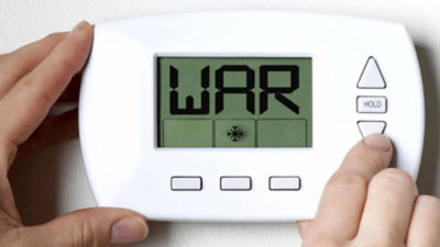 White thermostat that says WAR on screen