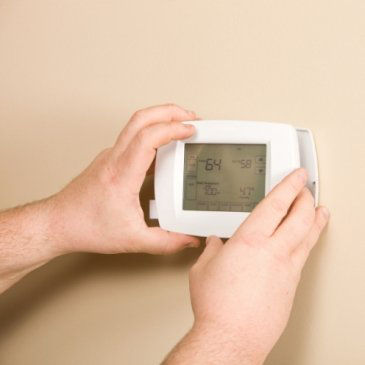 Man Adjusting Thermostat