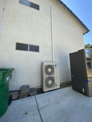 An AC unit connected to a building.