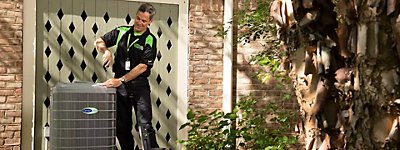 Technician working on an air conditioner or heat pump - Thomas & Galbraith Heating, Cooling and Plumbing