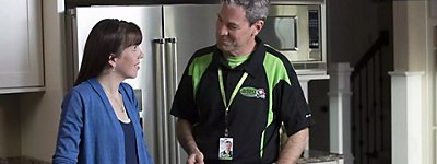 Technician discussing cost savings with a client - Thomas & Galbraith Heating, Cooling, & Plumbing