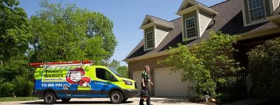 Technician walking in front of Thomas & Galbraith truck, arriving to complete a repair - Thomas & Galbraith Heating, Cooling & Plumbing