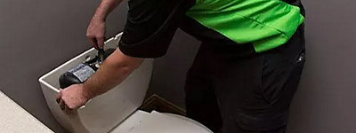 Plumber repairing a toilet - Williams Comfort Air Heating, Cooling, Plumbing & More