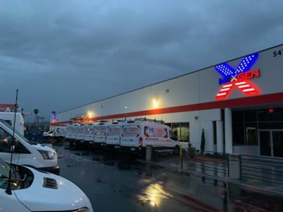 A row of NexGen Trucks parked oustide 