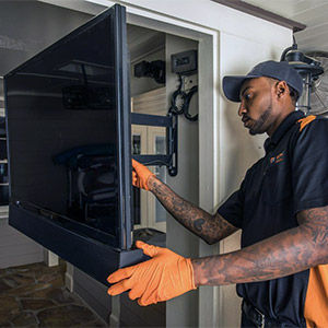 Electrician installing a TV