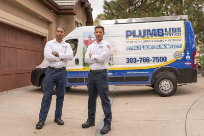 two technicians in front of Plumbline van