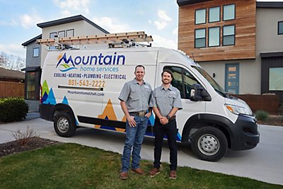 Two techs outside in front of van