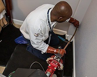 Plumber working on clogged drain