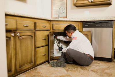 Working on Pipes Under the Sink