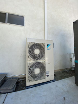 An AC unit connected to a building.