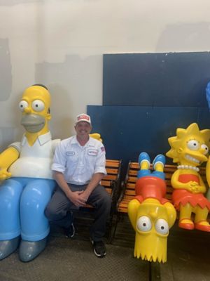 Nexgen Tech sitting with Simpson characters Homer, Bart and Lisa