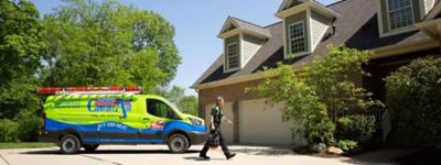 Technician walking in front of Williams Comfort Air truck, arriving to complete a repair - Williams Comfort Air Heating, Cooling, Plumbing & More