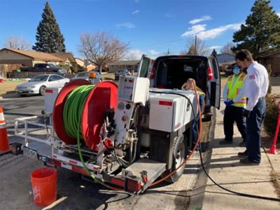 Performaing high-pressure drain jetting to clear a clog at a Denver home