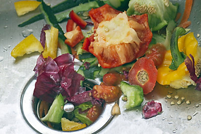 Colorful, raw, organic vegetable peelings in a metal sink