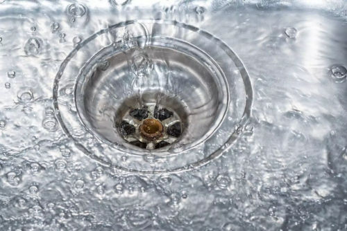 Water flowing into a sink drain