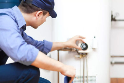 Image of technician adjusting a water heater