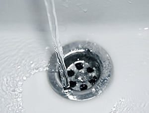 Water pouring down clear drain