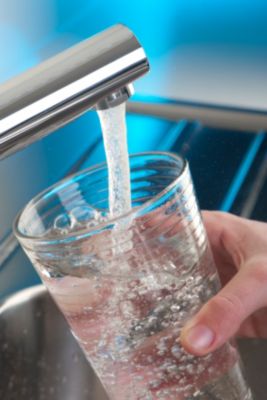 Filling up glass with drinking water from tap