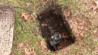 water pump in hole in a backyard