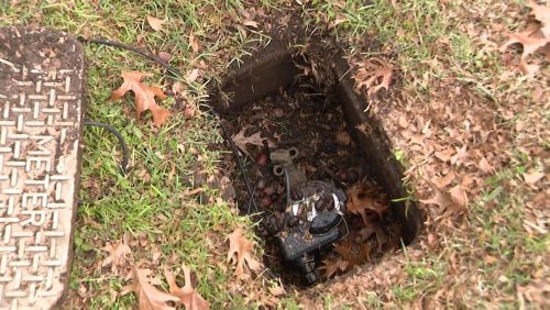 water pump in hole in a backyard