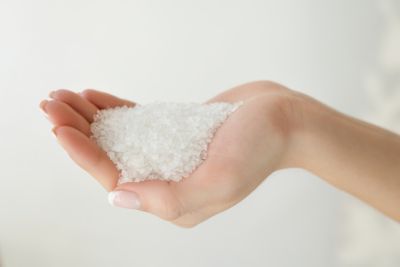 salt that goes into a water softener being held in a hand