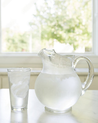 A pitcher and a glass of water on a table - Williams Comfort Air Heating, Cooling, Plumbing & More