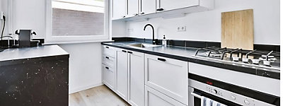 White cabinets with black hardware and black matte kitchen faucet<
