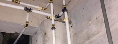 White PEX plumbing pipes running through a home