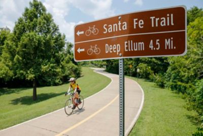 A cyclist rides along the White Rock Creek Trail at White Rock Lake in Dallas