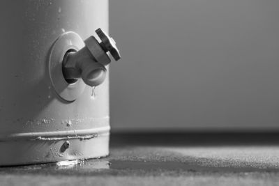 Close up image of a leaking water heater