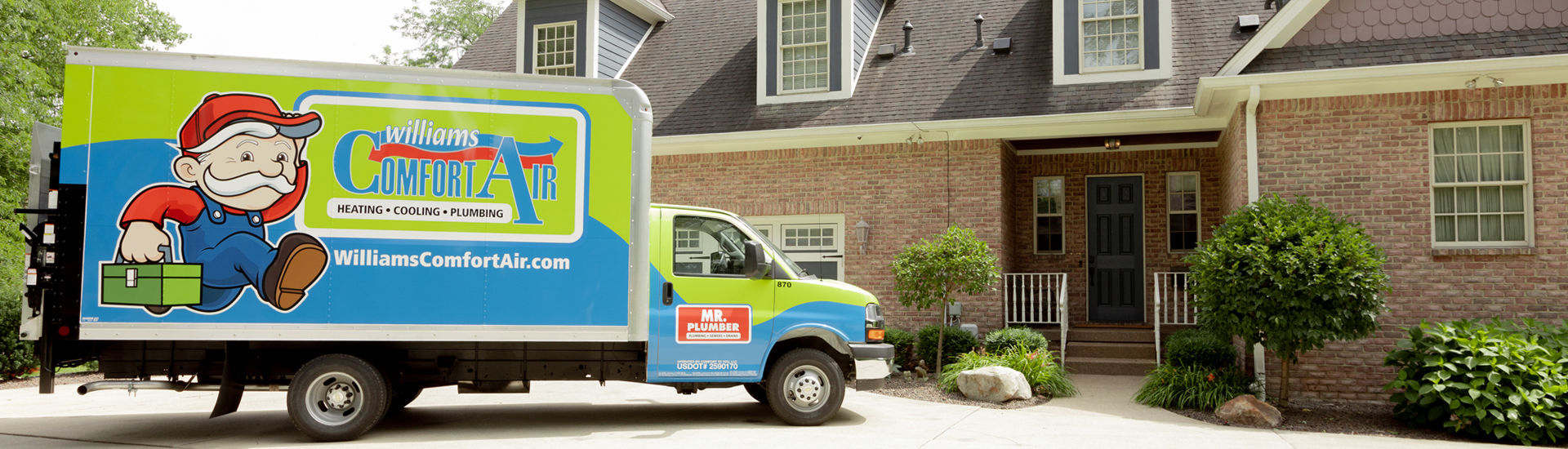 A Williams Comfort Air van parked in front of a house