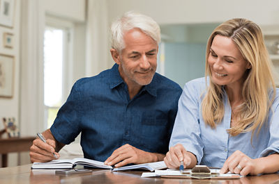 woman and man looking at bills