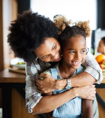 an image of a woman hugging a child from behind