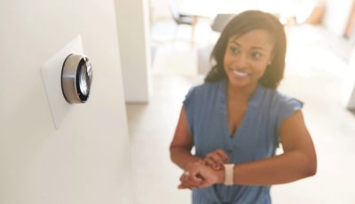 Woman looking at thermostat