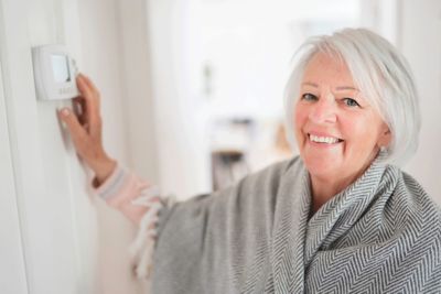 Woman Adjusting the thermostat